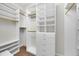 Organized walk-in closet with white shelving, drawers, and gold-tone rods for hanging clothes at 307 Running Wind Ln, Maitland, FL 32751