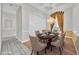 Dining room featuring a chandelier, six chairs, and white wall paneling with a wood-look tile floor at 307 Running Wind Ln, Maitland, FL 32751