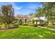 Inviting single-story home with a lush green lawn and mature trees, showcasing curb appeal at 307 Running Wind Ln, Maitland, FL 32751