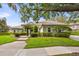 Beautiful single-story home with meticulously maintained landscaping, green grass, and mature trees at 307 Running Wind Ln, Maitland, FL 32751
