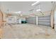 Large three car garage with ample storage space and metal roll-up doors at 307 Running Wind Ln, Maitland, FL 32751