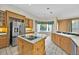 Large kitchen with an island cooktop, stainless refrigerator, and ample counter space at 307 Running Wind Ln, Maitland, FL 32751