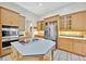 Well-appointed kitchen with stainless steel appliances and an island with cooktop at 307 Running Wind Ln, Maitland, FL 32751