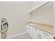 Laundry room with sink, storage cabinets, and a modern washing machine at 307 Running Wind Ln, Maitland, FL 32751
