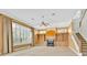 Open-concept living room with a fireplace, built-in shelving, and large windows offering ample natural light at 307 Running Wind Ln, Maitland, FL 32751