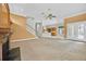 Spacious living room with a fireplace, staircase, and an open view of the kitchen at 307 Running Wind Ln, Maitland, FL 32751