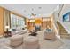 Staged living room with fireplace, built-in shelving, staircase, large windows, and plush seating at 307 Running Wind Ln, Maitland, FL 32751