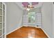 Bright home office with hardwood floors, built-in bookshelves, and a large arched window at 307 Running Wind Ln, Maitland, FL 32751