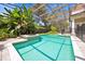 Tranquil pool with covered enclosure and mature landscaping for privacy at 307 Running Wind Ln, Maitland, FL 32751