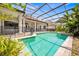 Private screened-in pool surrounded by lush greenery and a safety fence at 307 Running Wind Ln, Maitland, FL 32751