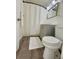Compact bathroom featuring a toilet, vanity and shower with curtain at 31538 Anderson Dr, Tavares, FL 32778