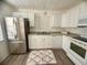 Bright kitchen featuring white cabinets, modern appliances, and a window over the sink at 31538 Anderson Dr, Tavares, FL 32778
