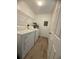 Functional laundry room featuring a washer, dryer, and overhead shelving at 31538 Anderson Dr, Tavares, FL 32778