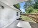 The backyard has a concrete patio, a well-maintained lawn, and a new wooden fence offering privacy and charm at 3321 Mahalia Pl, Orlando, FL 32805