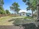 A spacious backyard showcases lush lawn with mature trees, offering a serene and private outdoor setting at 3321 Mahalia Pl, Orlando, FL 32805