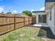 A spacious backyard with new wooden fence, complemented by a concrete patio and freshly laid mulch at 3321 Mahalia Pl, Orlando, FL 32805