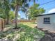 Backyard with a new privacy fence, mature trees, and freshly mulched areas at 3321 Mahalia Pl, Orlando, FL 32805
