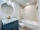 Updated bathroom with a stylish blue vanity, marble countertop, and elegant gold fixtures at 3321 Mahalia Pl, Orlando, FL 32805
