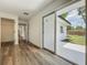 Bright bedroom with wood floors, featuring a closet, sliding glass door access to the backyard at 3321 Mahalia Pl, Orlando, FL 32805