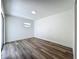 A modern bedroom features wood-look floors, a sliding door, and neutral walls for a bright and airy feel at 3321 Mahalia Pl, Orlando, FL 32805