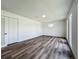 Bedroom featuring modern wood flooring, neutral walls, closet, and windows for natural light at 3321 Mahalia Pl, Orlando, FL 32805