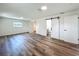An open bedroom with wood-look flooring and modern doors leading to closet and bathroom at 3321 Mahalia Pl, Orlando, FL 32805