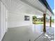 Bright and airy carport with a freshly painted floor and support beams at 3321 Mahalia Pl, Orlando, FL 32805