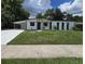 Beautifully renovated single-story home with a manicured lawn and modern carport at 3321 Mahalia Pl, Orlando, FL 32805