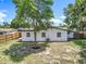 Landscaped yard features a charming wood fence and mature trees, enhancing privacy and curb appeal of the home at 3321 Mahalia Pl, Orlando, FL 32805