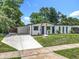 Charming single-story home with freshly painted exterior, modern carport, and landscaped yard at 3321 Mahalia Pl, Orlando, FL 32805