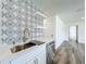 Kitchen details include decorative tile, open shelving, and stainless steel sink at 3321 Mahalia Pl, Orlando, FL 32805
