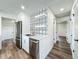 White kitchen with stainless steel appliances and hallway access at 3321 Mahalia Pl, Orlando, FL 32805