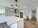 Modern kitchen with stainless steel appliances, quartz countertops, and designer backsplash at 3321 Mahalia Pl, Orlando, FL 32805