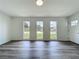 Living room with neutral decor featuring hardwood floors, white walls, and natural light from multiple windows at 3321 Mahalia Pl, Orlando, FL 32805