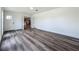 Open living room with stylish wood floors, white walls, and ample natural light from the front door at 3321 Mahalia Pl, Orlando, FL 32805