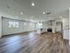 Spacious living area with wood flooring and an open view of the kitchen at 3321 Mahalia Pl, Orlando, FL 32805
