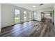 Bright living room with sleek flooring, white walls, and multiple windows providing plenty of natural light at 3321 Mahalia Pl, Orlando, FL 32805
