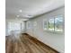 Bright living room featuring stylish wood floors, white walls, and ample natural light from multiple windows at 3321 Mahalia Pl, Orlando, FL 32805