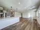 Open-concept living room and kitchen area featuring wood flooring at 3321 Mahalia Pl, Orlando, FL 32805