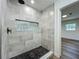 Shower featuring decorative mosaic floor and wall tile with recessed lighting at 3321 Mahalia Pl, Orlando, FL 32805