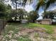 The serene fenced backyard features a shed and lush landscaping, perfect for outdoor enjoyment at 34 W Bob White St, Apopka, FL 32712