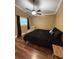 Cozy bedroom with ceiling fan, side chair, and laminate wood flooring at 34 W Bob White St, Apopka, FL 32712