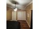 Bedroom features a ceiling fan, laminate wood flooring and a spacious closet at 34 W Bob White St, Apopka, FL 32712