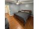 Comfortable bedroom featuring laminate floors, a ceiling fan, and a standard closet at 34 W Bob White St, Apopka, FL 32712