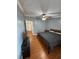 Comfortable bedroom featuring laminate floors, a ceiling fan, and a standard closet at 34 W Bob White St, Apopka, FL 32712