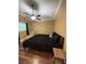 Bedroom features a ceiling fan, side chair, and laminate wood flooring at 34 W Bob White St, Apopka, FL 32712
