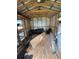 The interior of the shed includes storage shelving, tires, ladder, and a metal roof at 34 W Bob White St, Apopka, FL 32712