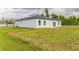 Exterior view of a home showing a spacious green backyard at 3832 Sw 157Th Place Rd, Ocala, FL 34473