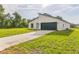 Contemporary home featuring a modern architectural design, well-maintained lawn, and a paved driveway at 3832 Sw 157Th Place Rd, Ocala, FL 34473