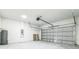 A two car garage with a white garage door and concrete floors at 3832 Sw 157Th Place Rd, Ocala, FL 34473